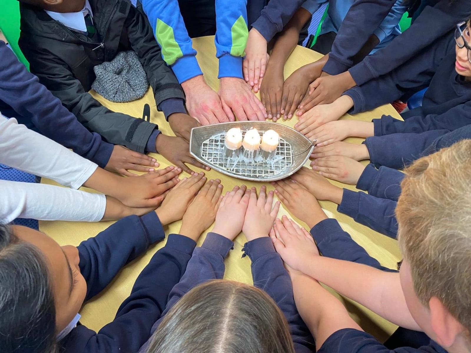 Project Touchline pupils gathered around candles during a reflective prayer activity